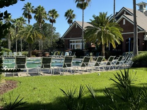 Resort-style pool and palms at an Oakleaf Plantation amenity center